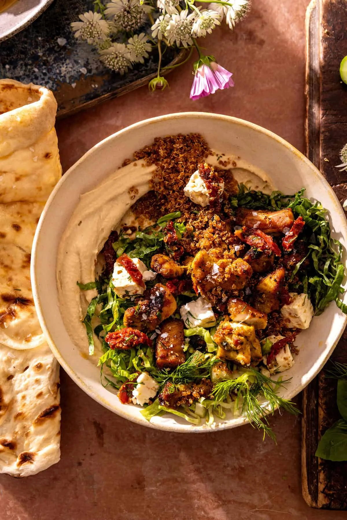 The Ultimate Chicken Shawarma Hummus Bowl with Crispy Quinoa and Feta Tomato Salad